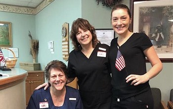 Smiling team at front desk