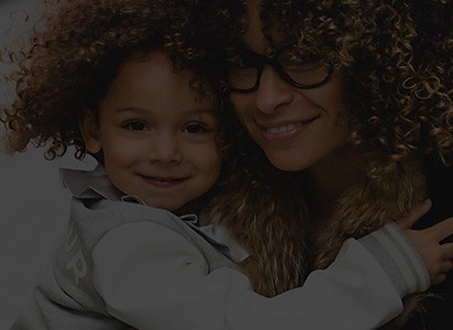 Mother and young daughter smiling together