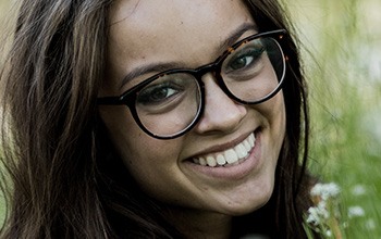 Young woman with glasses and beautiful smile