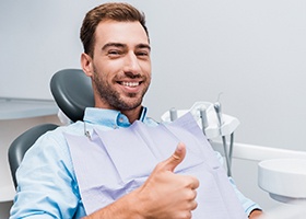 Bearded male dental patient giving a thumbs up