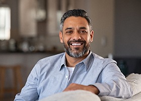 Man sitting on his couch and smiling