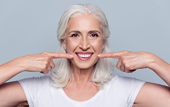 a patient smiling and showing off their dentures