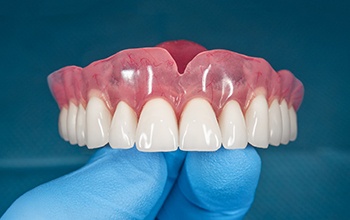 a dentist holding a denture