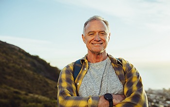 a smiling person who’s on a hike