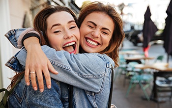 Patient in Rochester smiling confidently with friend