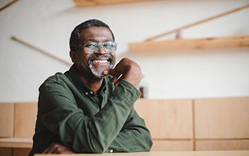 man smiling after getting dental implants in Rochester