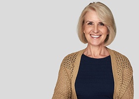 woman smiling with dental implants in Rochester a white background 