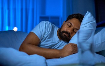 Man resting with dental implants in Rochester  