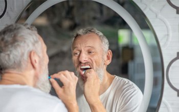 Man brushing teeth in Rochester   