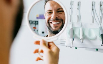 Man smiles with dental implants in Rochester   