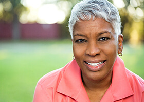 Happy, healthy woman with dental implants in Rochester
