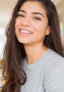 Dentist smiling at patient's dental exam