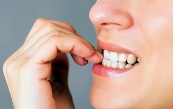 Closeup of patient biting their nails