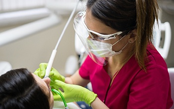 dentist performing scaling and root planing in Greece on a patient with gum disease