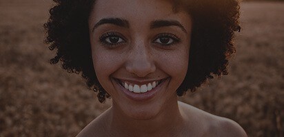 Woman smiling in outdoor field