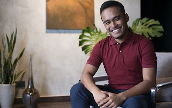 smiling person sitting on a chair