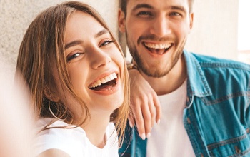 Couple smiles after repairing cavities in Rochester