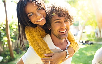 Couple smiling after learning the cost of teeth whitening in Rochester