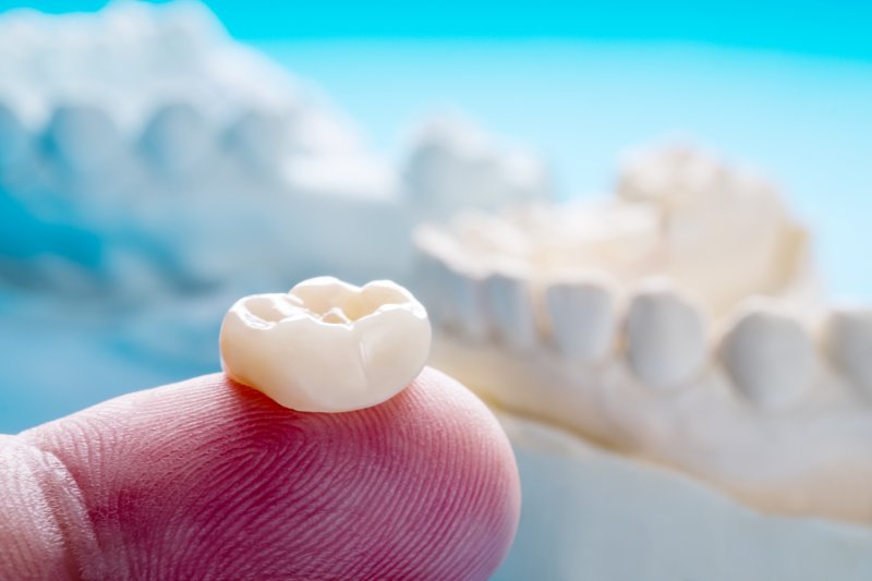 Closeup of person holding dental crown