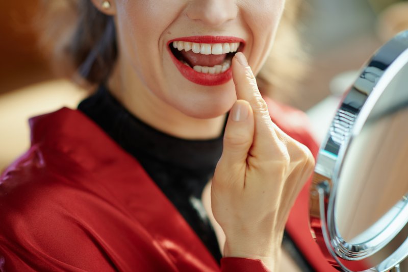 Woman smiling with dental crown in Rochester