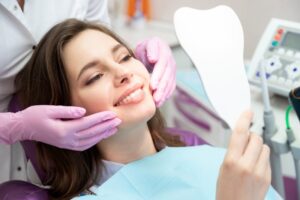 Woman smiling after getting dental veneers