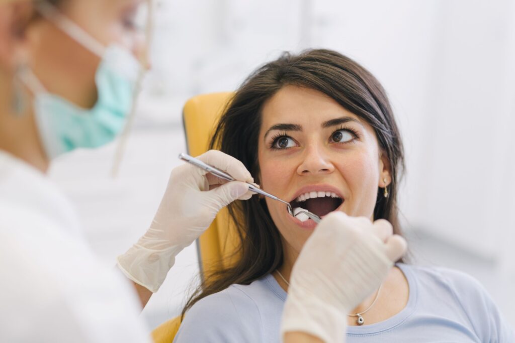 Woman with dark hair undergoing dental exam